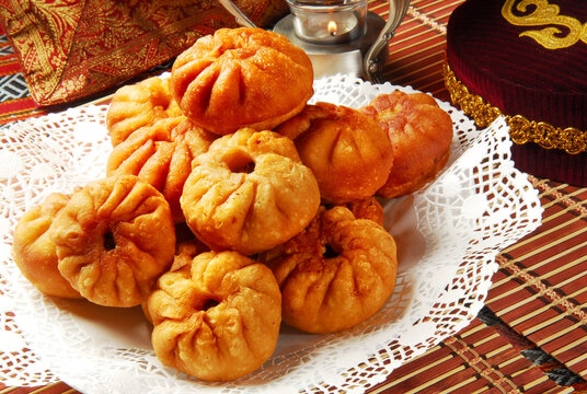 Group of individual pies with meat and potato - vak balish. Tatar traditional pies. Wooden background. Top view.