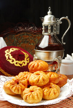 Group of individual pies with meat and potato - vak balish. Tatar traditional pies. Wooden background. Top view.