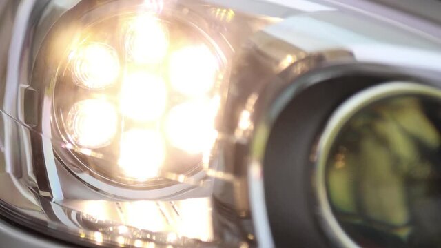 Turning on xenon car headlights close up