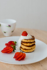 Delicious homemade pancakes pancake with strawberries and circles with tea
