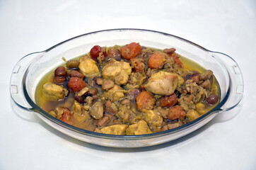 Traditional oriental dish . on tableware . Azerbaijan , Baku . Shah Pilaf . Asqara . Asgara . Ingredients soup, chestnut, plum, chicken. Shah pilaf black. Pilafblack in a pita.