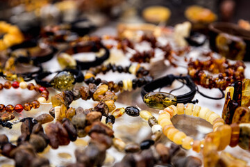 Close-up of amber jewelry lying on a sales counter