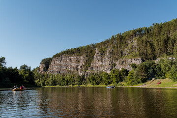 summer day on the river with rocky banks, blue sky, mountains, forest, landscape, river AI