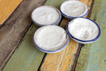 Streaming coconut milk custard in small porcelain cup. Thai dessert.