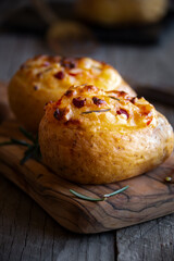 Baked potatoes stuffed with cheese, vegetables and rosemary
