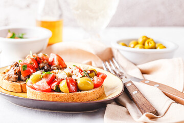 Delicious bruschettas with mushrooms, blue cheese, olives and tomatoes