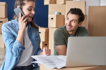 Cheerful couple getting things done via phone