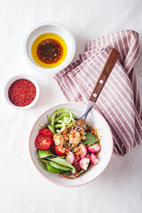 Fresh salad with couscous, tomatoes, cucumber, radish and chard.