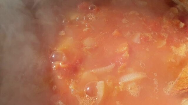 Close-up of boiling vegetable stew. Hot steam rises over food