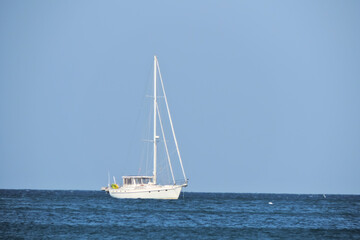    white sailing boat drifts into the sea   