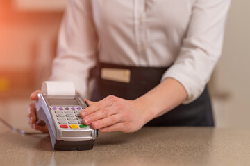 The waiter accepts payment through the terminal, non-cash payment. Restaurant business
