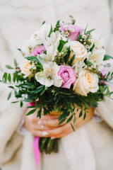 wedding flower bouquet in the hands of the bride