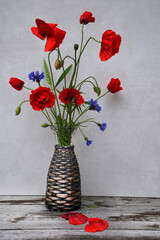 Poppies flowers with cornflowers in vase 
