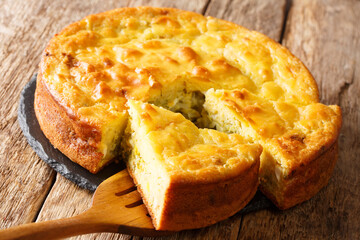 Slavic pie stuffed with cabbage, herbs and boiled eggs close-up on a slate board on the table. horizontal