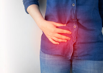 A woman suffers from pain in the appendix. Acute appendicitis, Crohn's disease, or inflammatory...