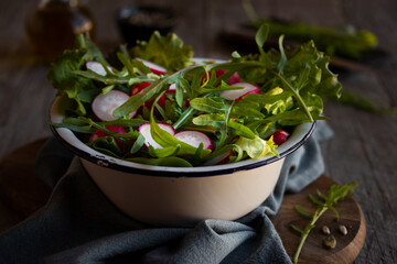 Fresh vegetable salad with radish, arugula and lettuce