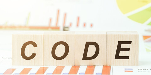 word code with black letters on wooden blocks on desk