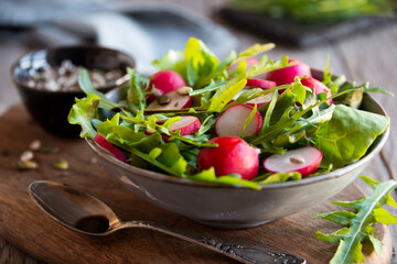 Fresh vegetable salad with radish, arugula and lettuce