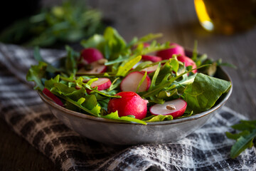 Fresh vegetable salad with radish, arugula and lettuce