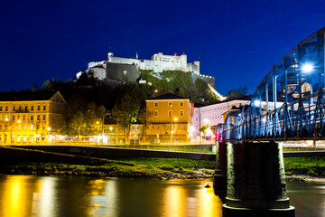 Beautiful view of Salzburg skyline with Festung Hohensalzburg and Salzach river at twilight,...
