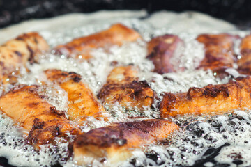 Fried pies in big pan, close up. Street food. Street market. Tasty fried pies.