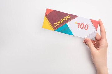 Cropped view of woman holding coupon with 100 dollars sign on white background