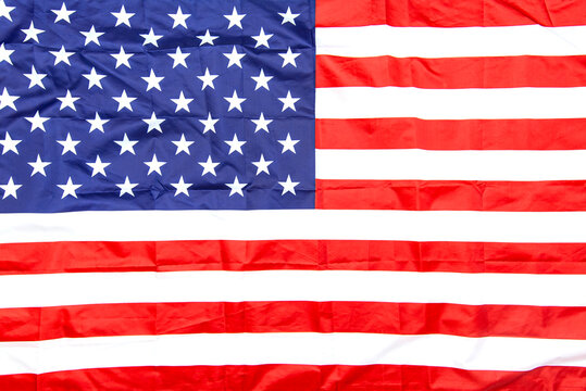 Natural fabric crumpled USA flag, rag American flag top view as texture or background, high resolution picture