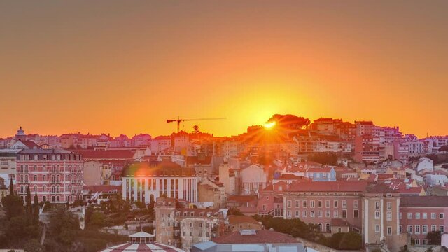 Sunrise over Lisbon aerial cityscape skyline timelapse from viewpoint of St. Peter of Alcantara, Portugal. Historical buildings from above at morning