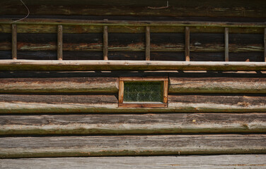 Forest and a small house in it on a summer day. A cabin in the woods.