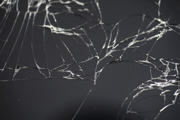 Crack on the glass. Broken screen. Broken phone. Cracked glass background. White cracks in the glass.