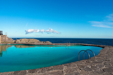 swimming pool in front of sea