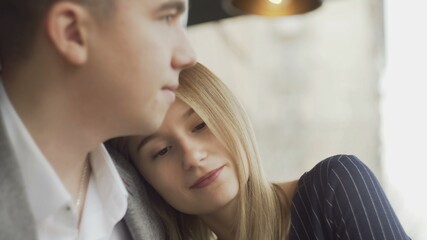Fototapeta premium Loving young couple hugging while resting in cafe