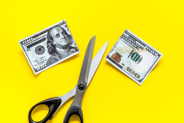 Decline of dollar exchange rate. Scissors cut dollars banknote