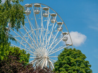 Amusement ride against blue sky. Close up with a white ferrys wheel.