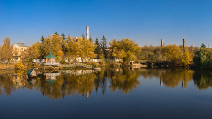 Fototapeta na wymiar Autumn landscape with a lake and yellow trees