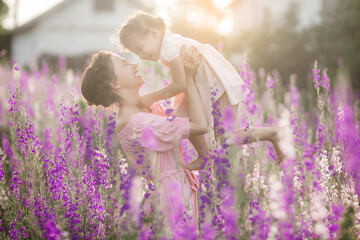 Very beautiful picture of young mother and child in the flower field