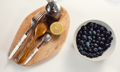 Blueberries in a bowl and utensils in a kitchen