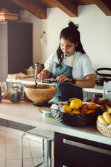 Asian woman cooking in a kitchen