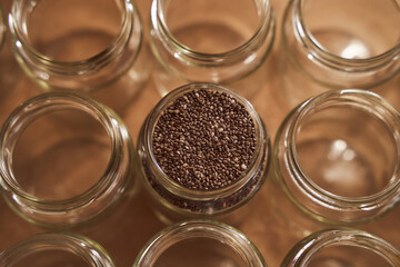 Glass jars. In one of which are the seeds of Chia. promotional photo