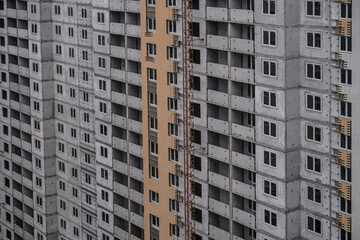 Fototapeta premium Large construction site on a background of blue sky. Brick, panel apartment building. Industrial theme for design