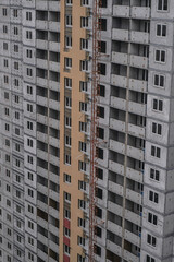 Fototapeta premium Large construction site on a background of blue sky. Brick, panel apartment building. Industrial theme for design