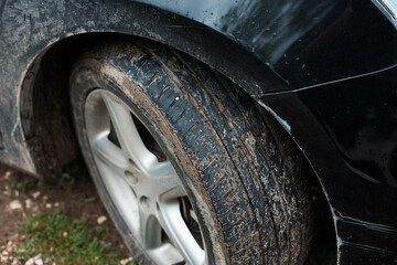 Fototapeta na wymiar Close up photo of dirty car and tires in a rainy day