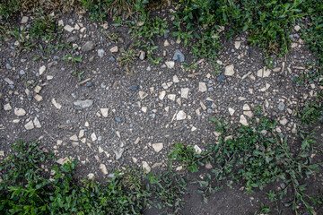 background and texture trodden path with stones closeup