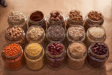 Super food grits in glass jars. Top view. lentils, chickpeas, corn, oats, beans, chia