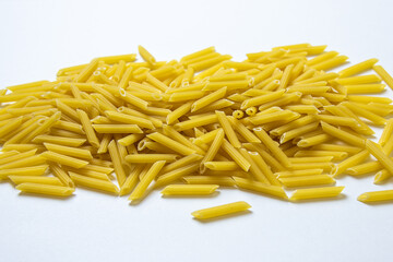 heap of pasta on a white background. raw pasta in a pile