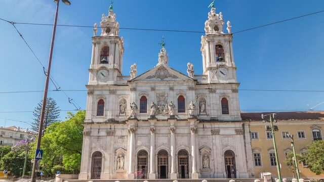 Front view on the Basilica da Estrela from the streets of Lisbon timelapse hyperlapse, Portugal. Traffic on the street and blue sky