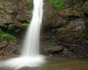 Waterfall near Buddhist temple at the head of a Japanese river.