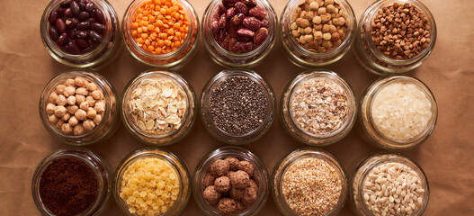 Super food grits in glass jars. Top view. lentils, chickpeas, corn, oats, beans, chia