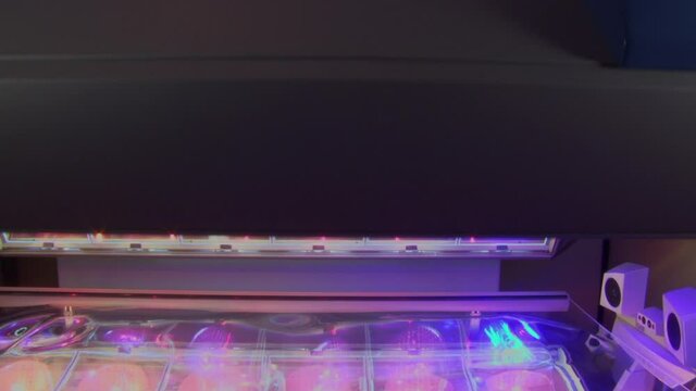 Sunbed lid being opened and closed to show pink and blue lamps inside