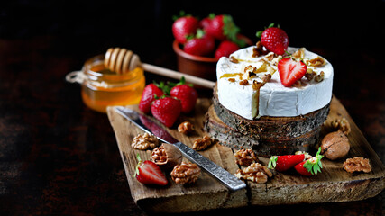 Camembert cheese with strawberries, walnuts and honey. Elegant keto snack. Keto diet.